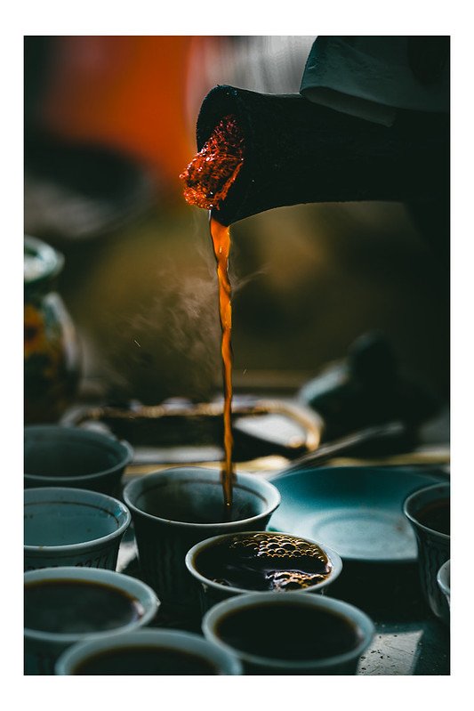 Coffee poured from a jebena into small cups