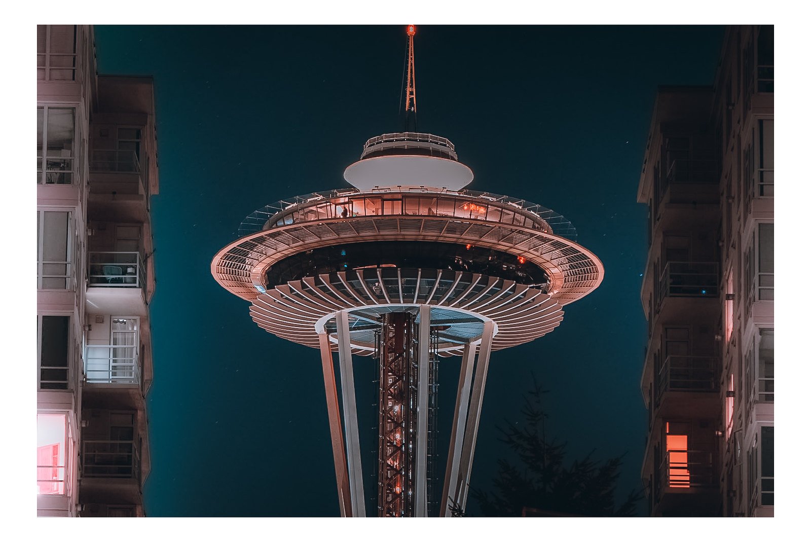 Space Needle at night framed between two buildings