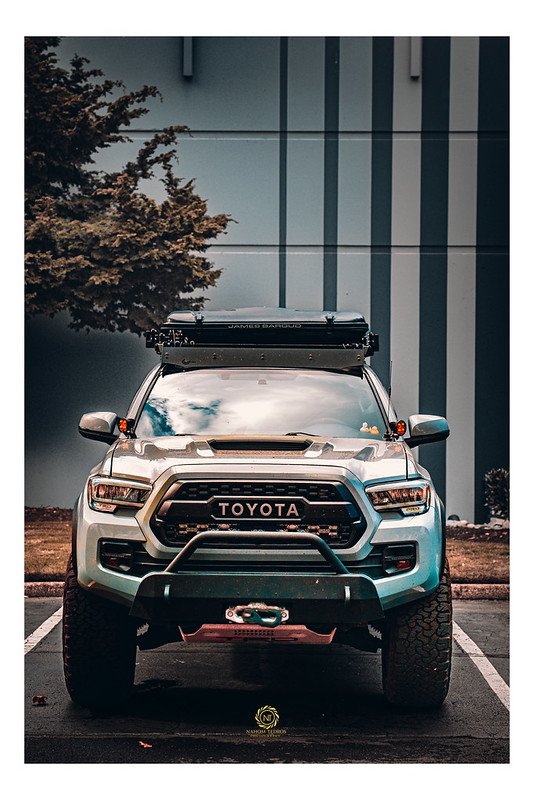 Silver Toyota Tacoma fitted with a roof tent